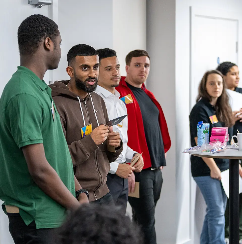 People standing and talking in a room.